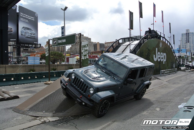 a jeep on a ramp in front of a bridge