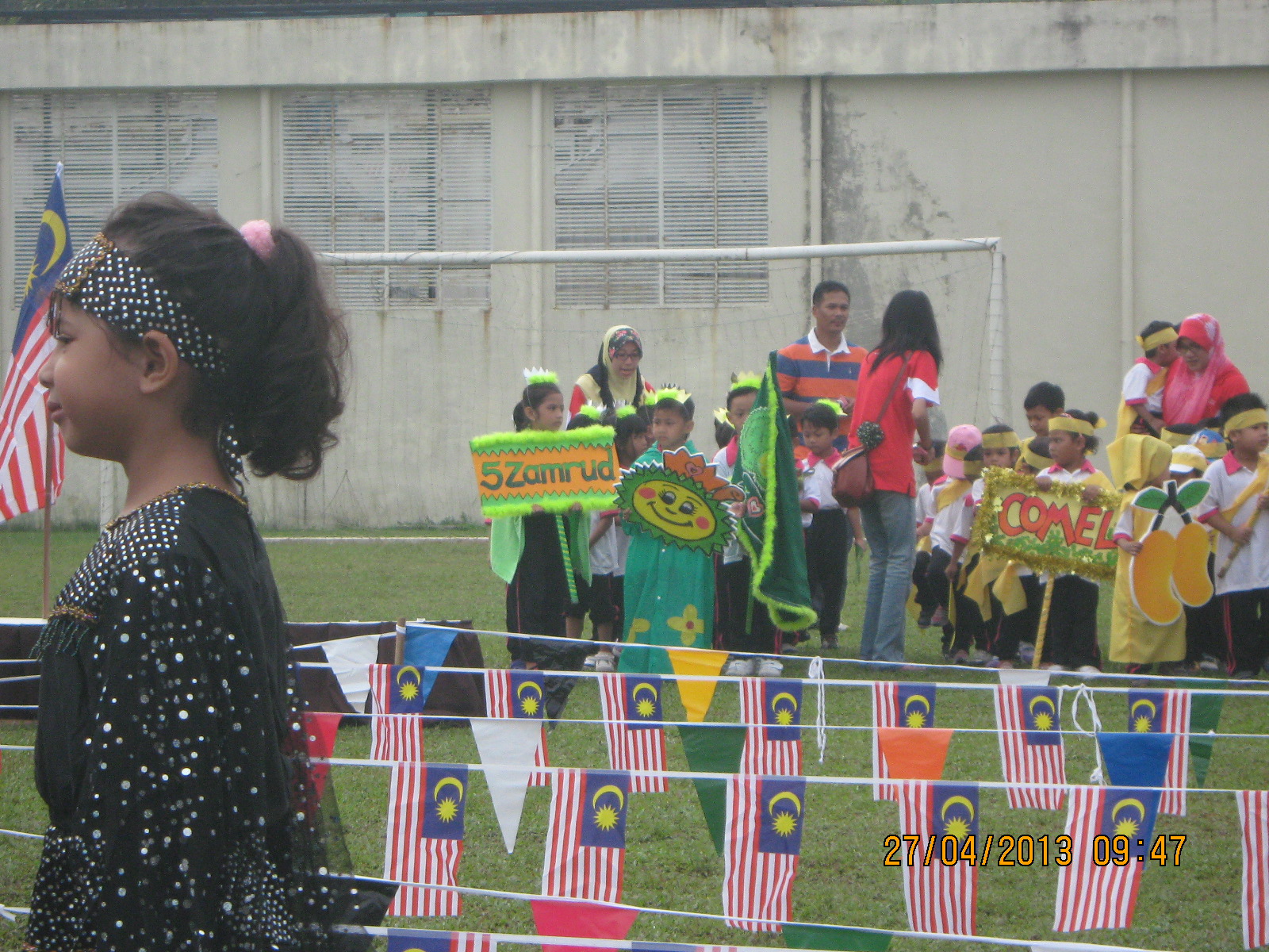 a group of children holding flags on the field