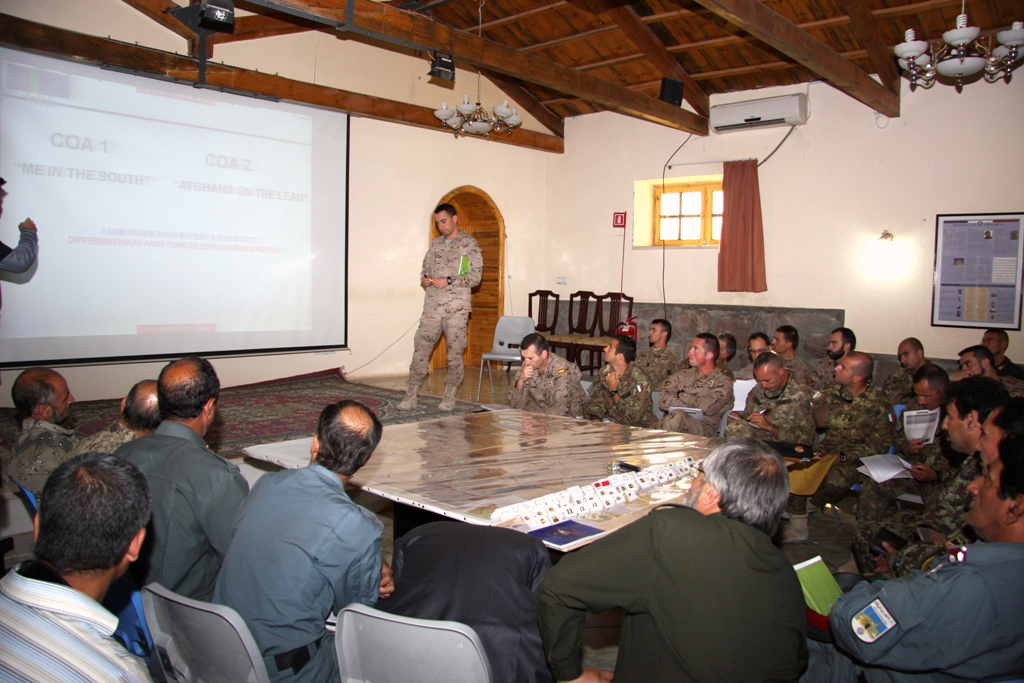 some soldiers sitting around in a large room