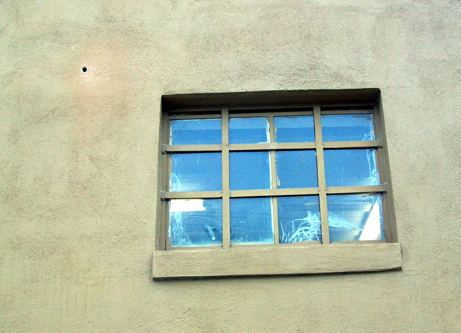 a po of a window that is made from a stucco wall