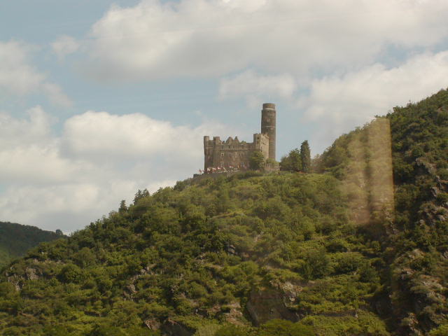 a castle perched on a hill overlooking another hill
