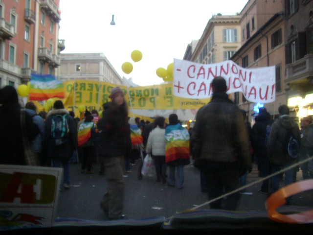 a group of people walking in the street with signs and balloons