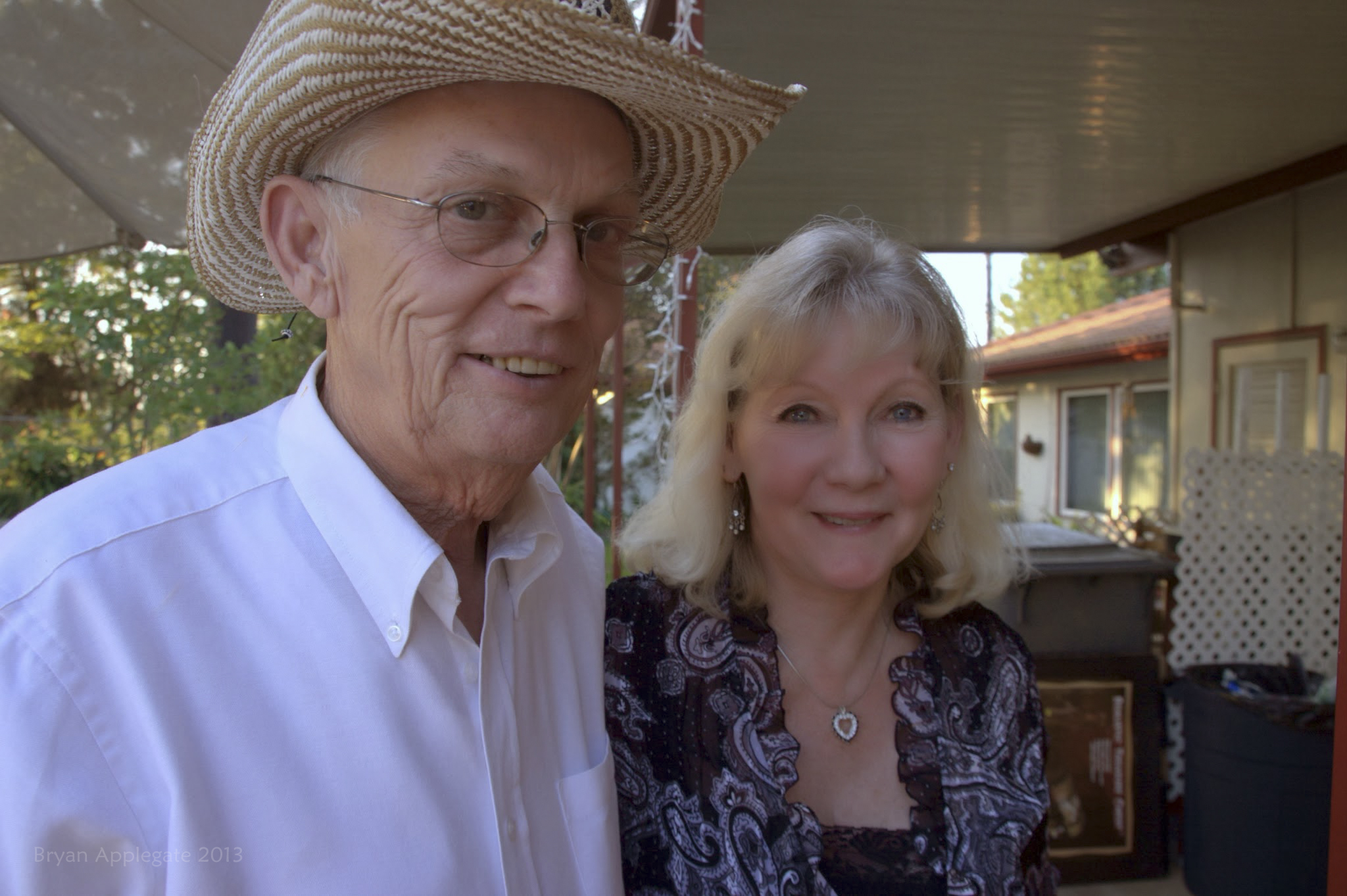 a woman with blonde hair and a man with a cowboy hat