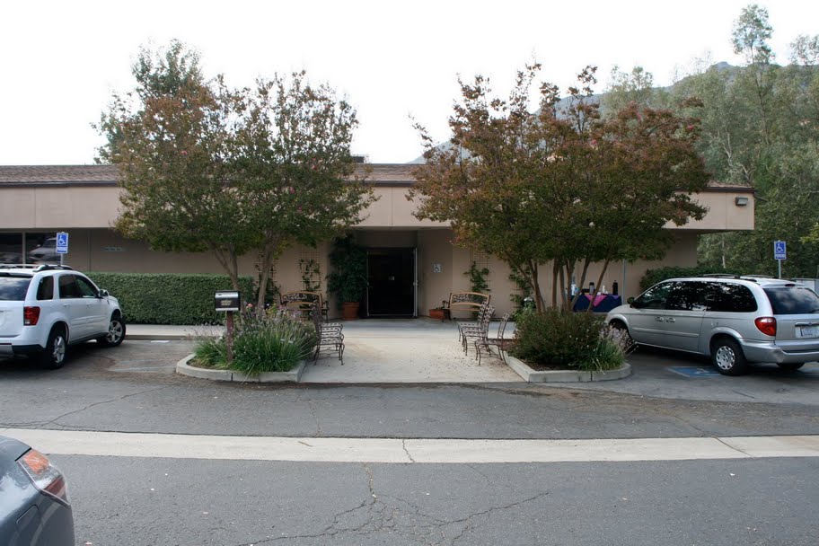 several cars parked in front of an empty office building