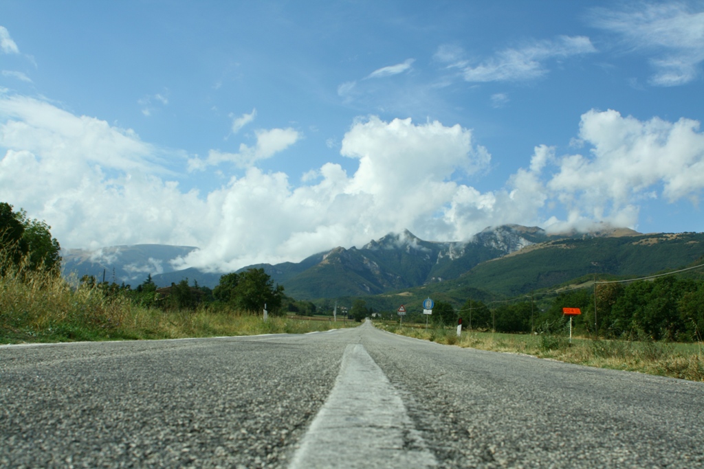 a rural road with a very big sign