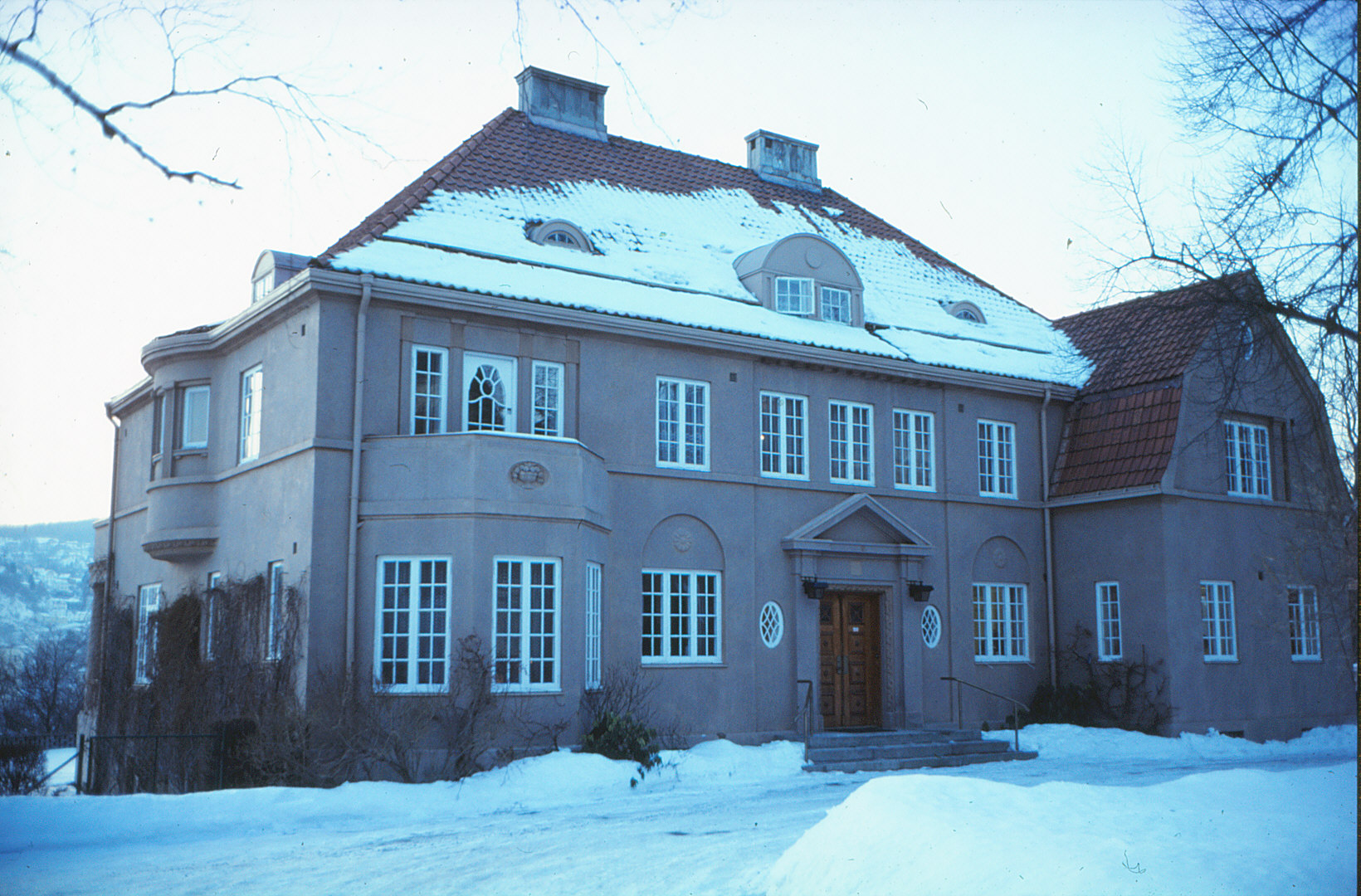 there is a large home with a snow covered roof
