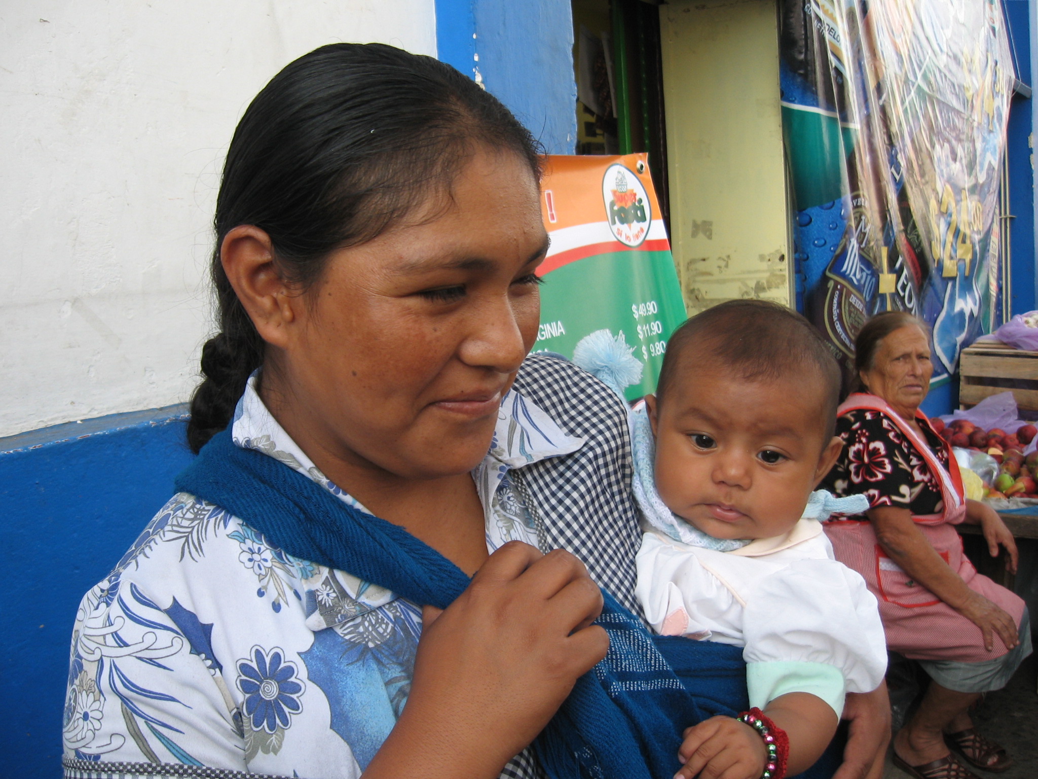 a lady holding a baby on the street