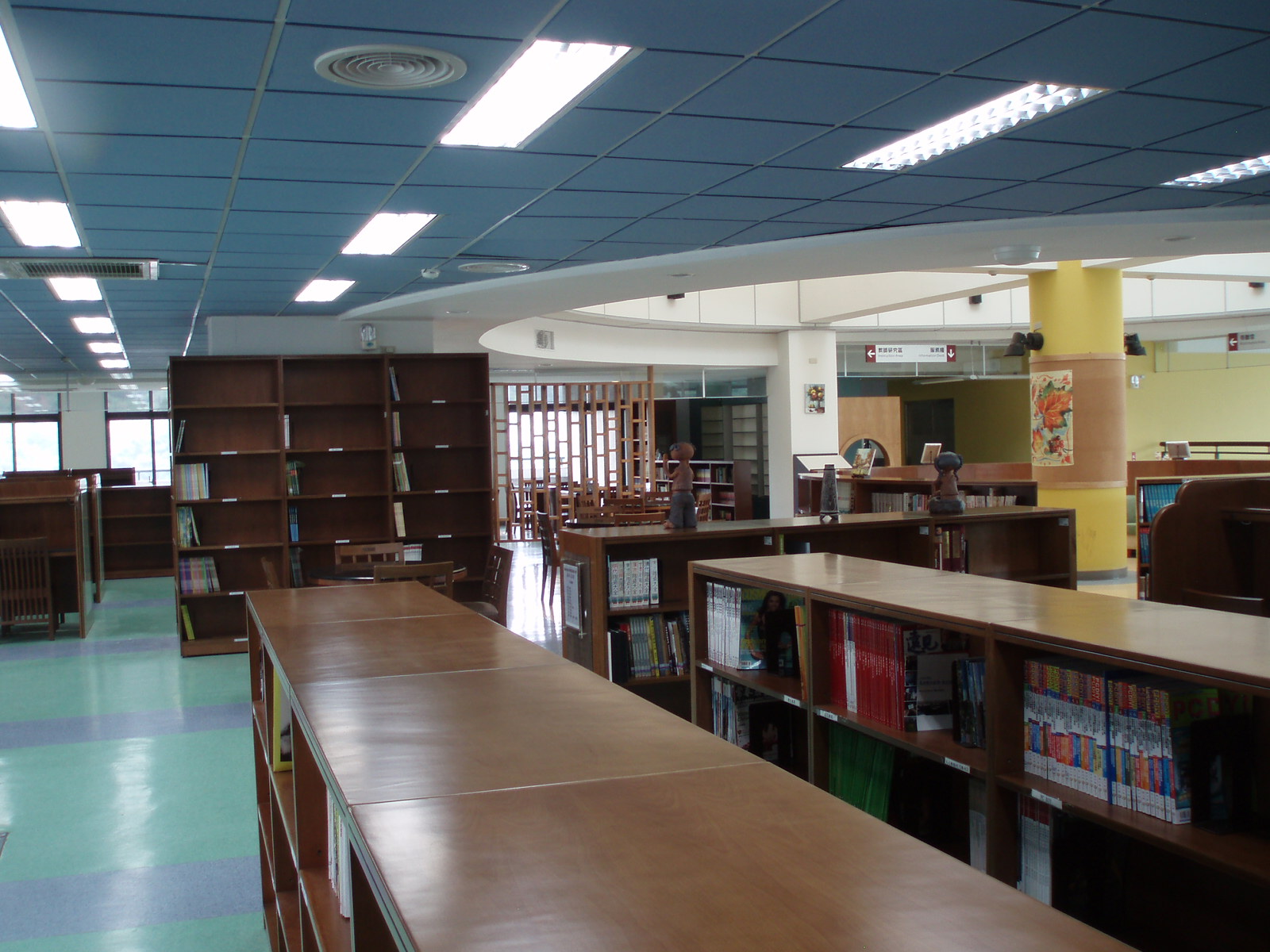 the liry has long tables, benches and a book shelf