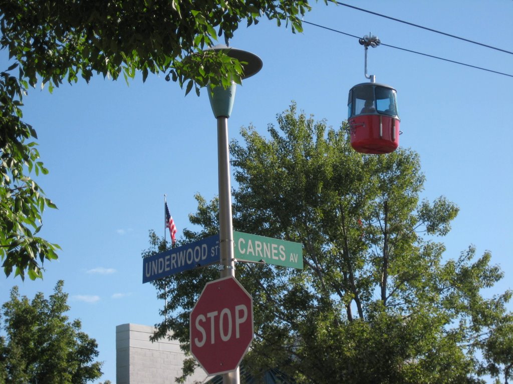 street signs are in front of a red trolly in the foreground