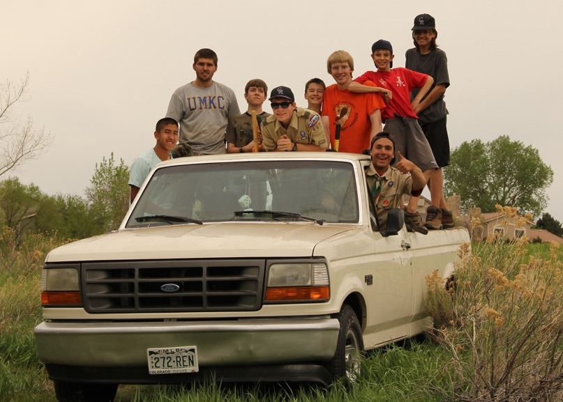 people posing for a po in front of a truck