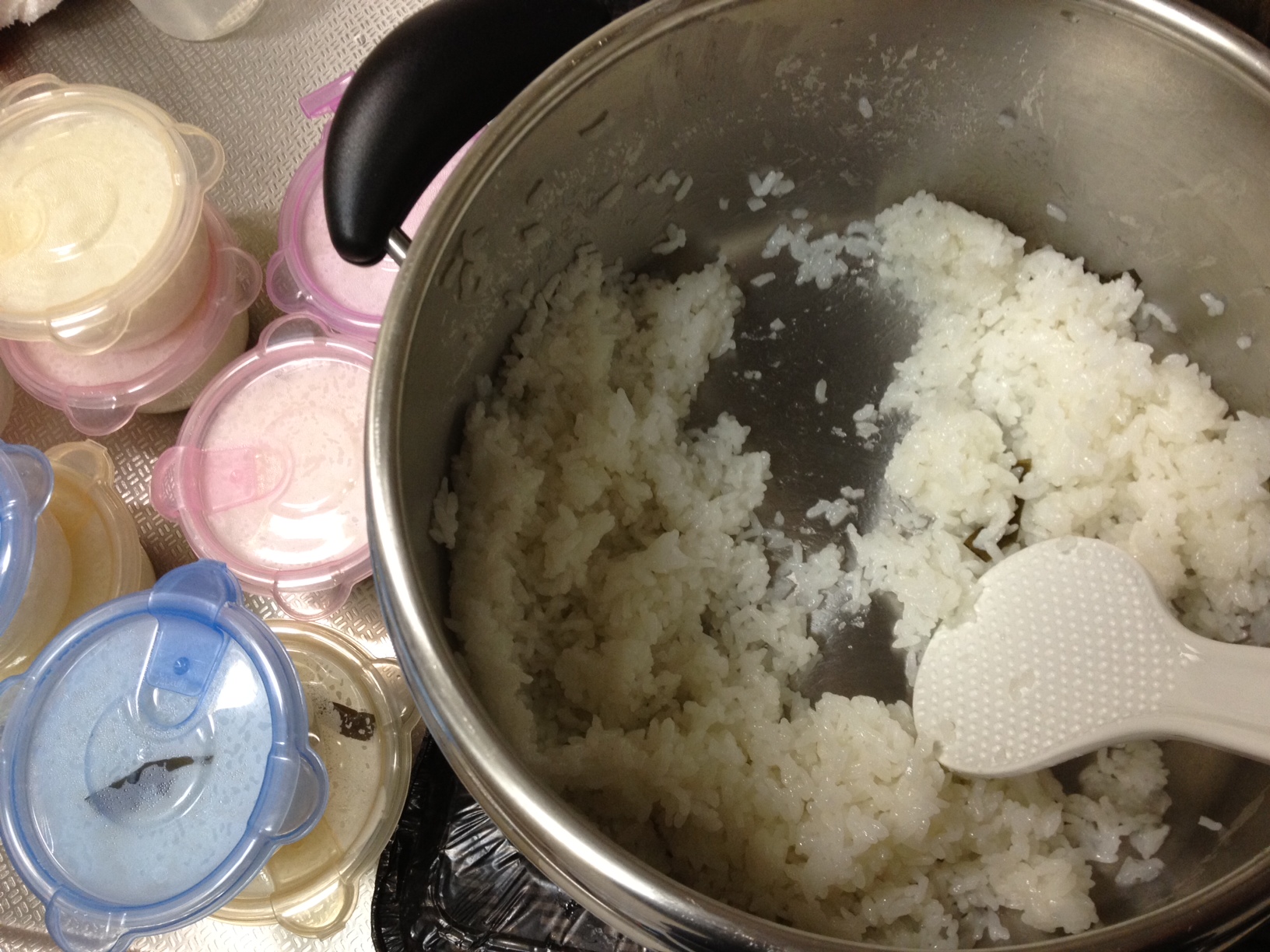 a pot of rice and spoons on a counter