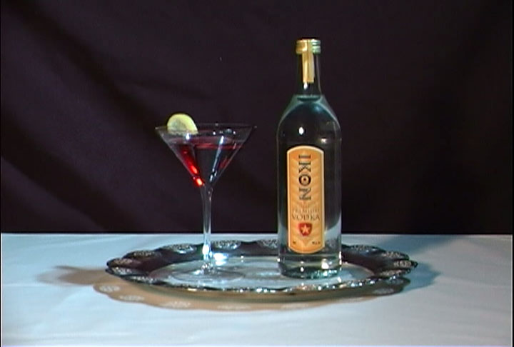 a bottle of liquor and a martini are sitting on a table