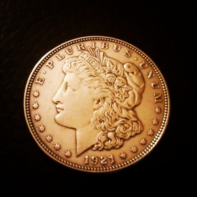 an old gold morgan dollar is pictured
