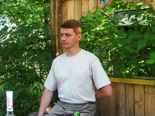 a man sitting on a bench in the garden