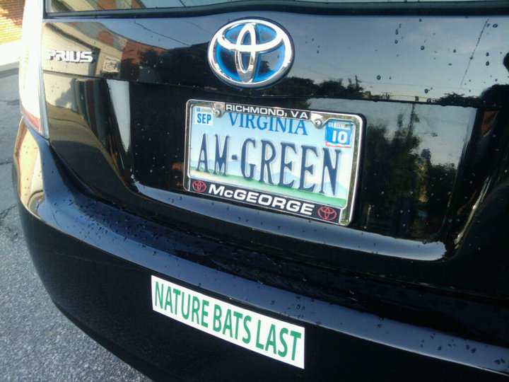 a black car has a license plate with a fish on it