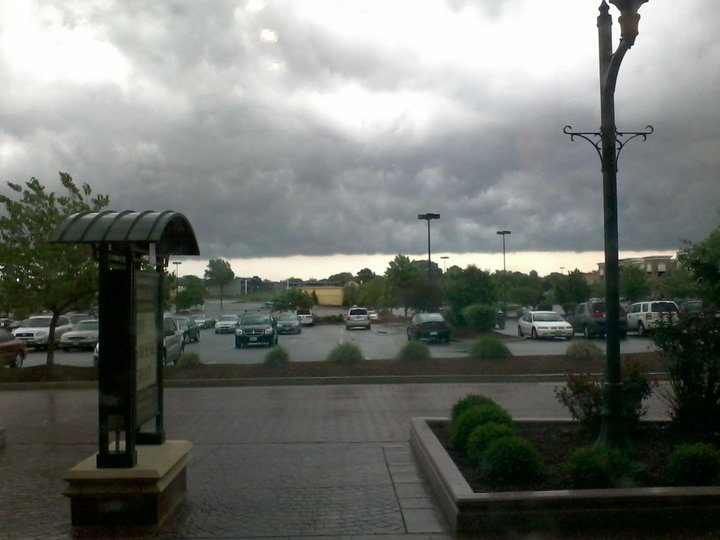 a parking lot with cars parked and onlookers