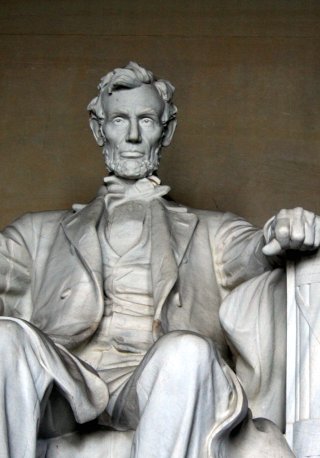 the statue of aham lincoln is sitting with his arms crossed