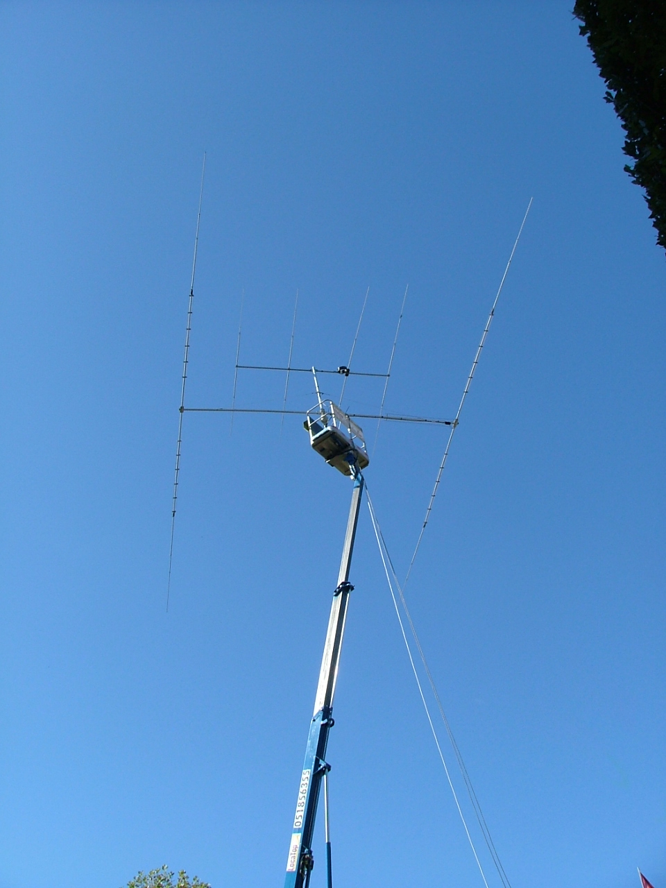 a large antenna sits in the blue sky