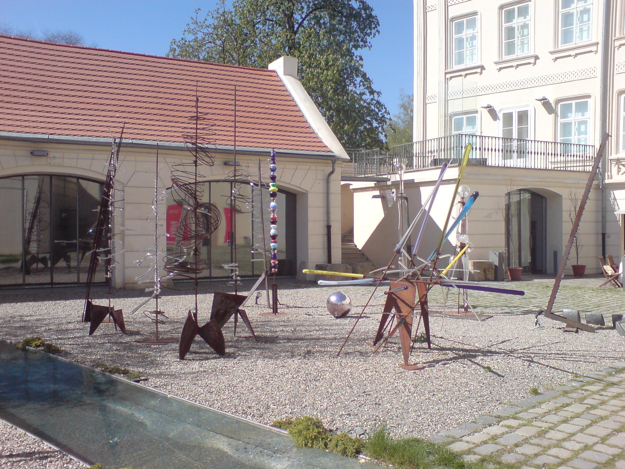 a playground with swings and balls next to a building