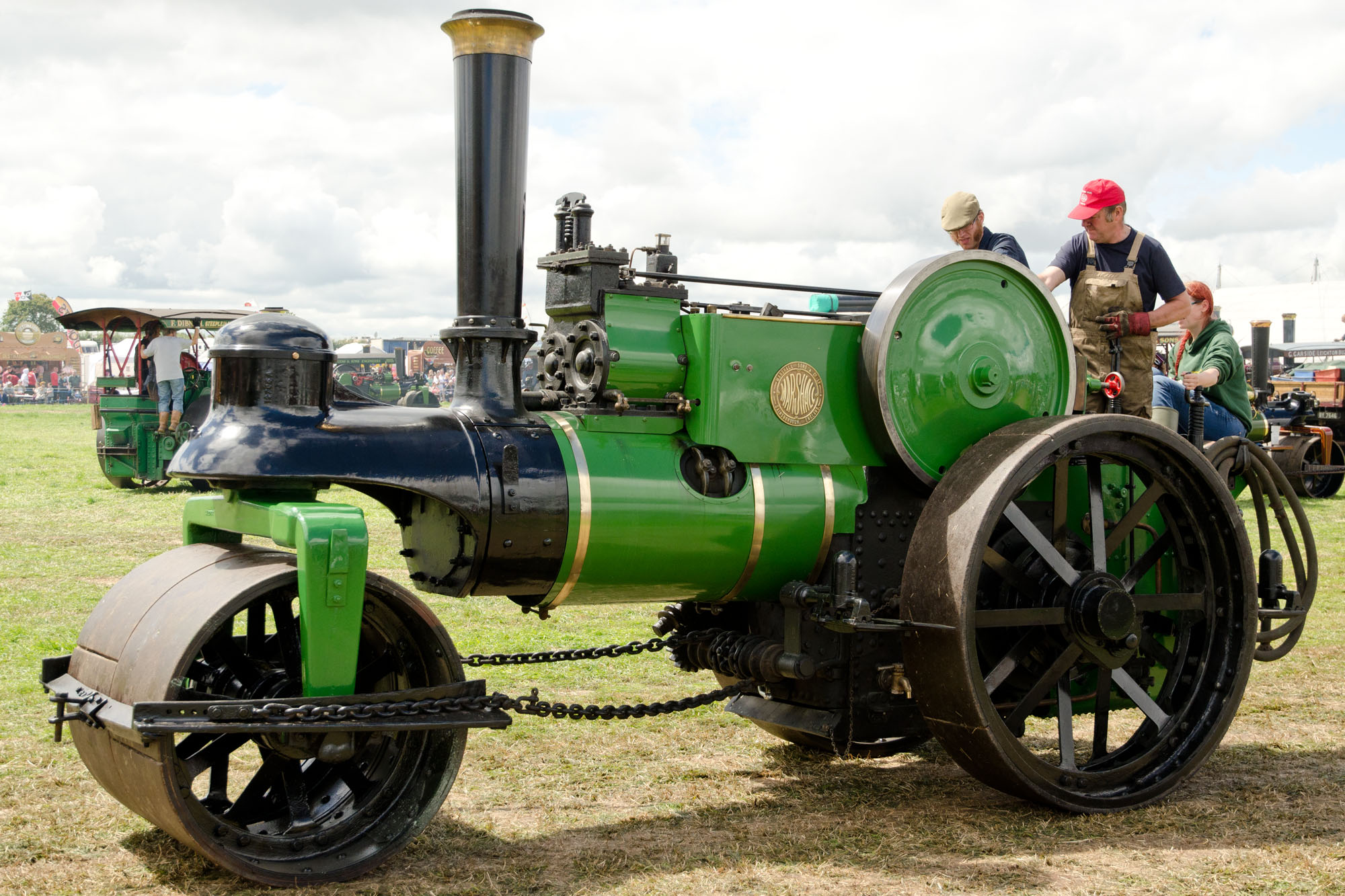 a green and black engine sitting on a field
