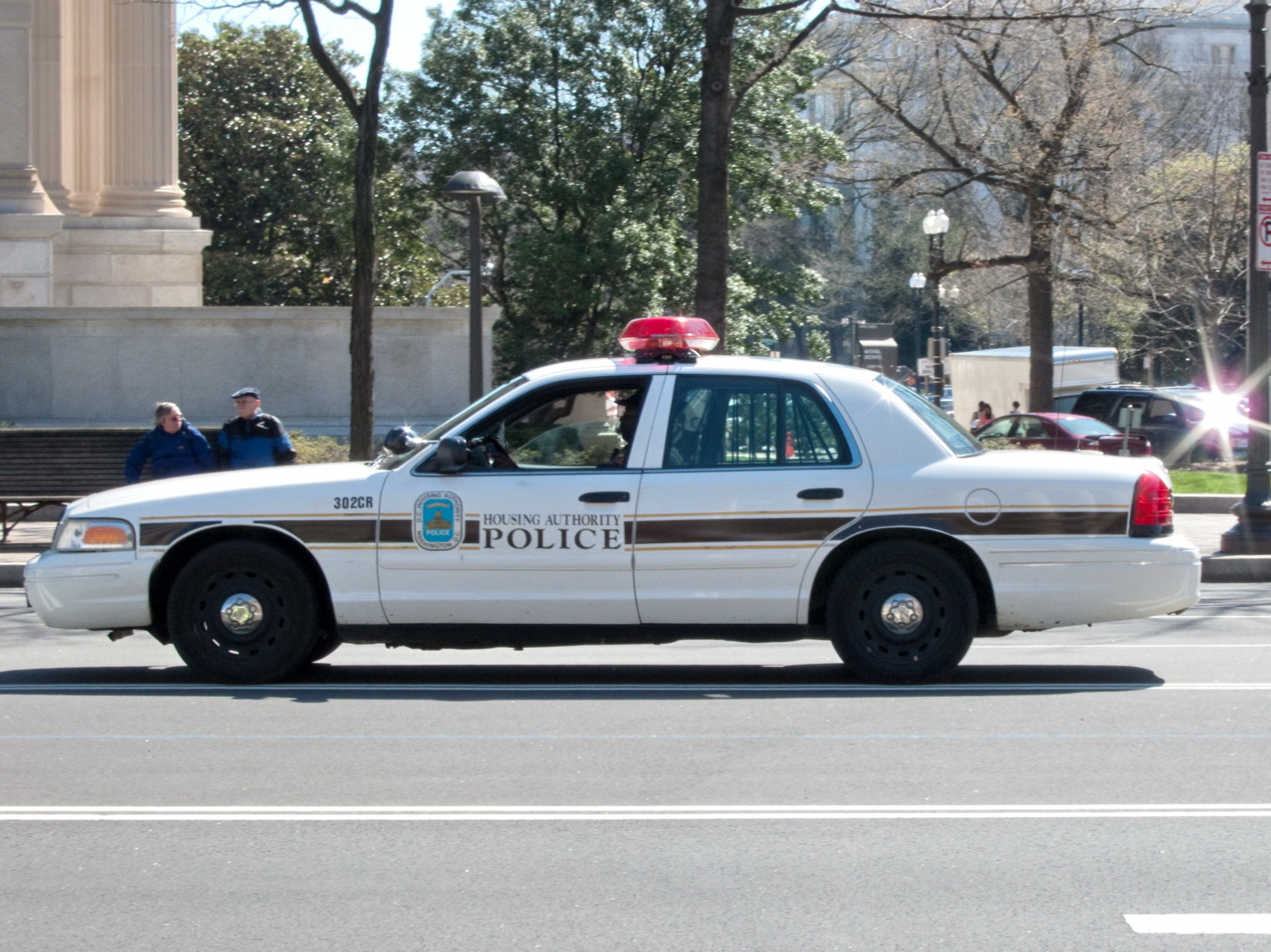 an automobile police car driving through the streets