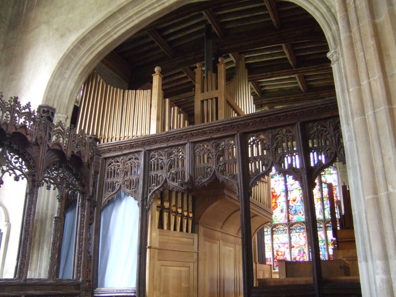 an ornate wooden altar with stained glass windows