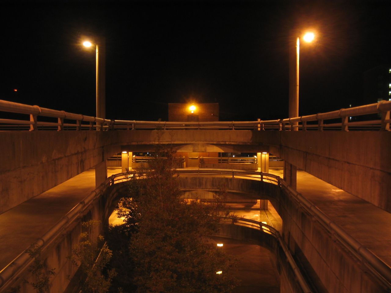 an underpass in a parking lot with street lights