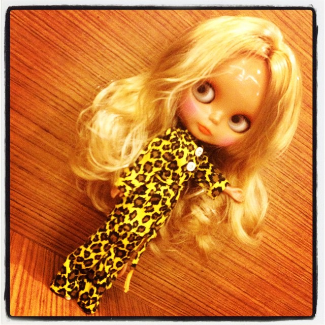 a doll with long hair and yellow shirt