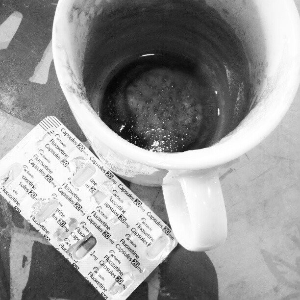 black and white po of tea in the cup with tickets