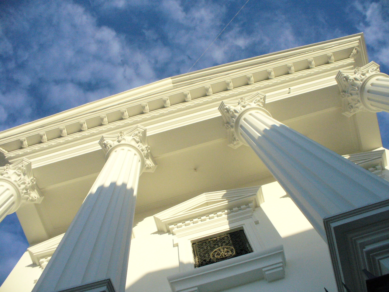 some very tall building with columns and a window