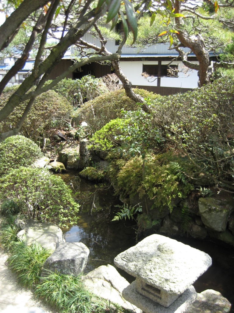 japanese garden setting with rock water and large boulders