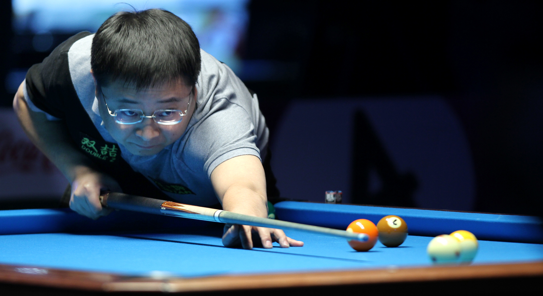 a person is playing a game of pool