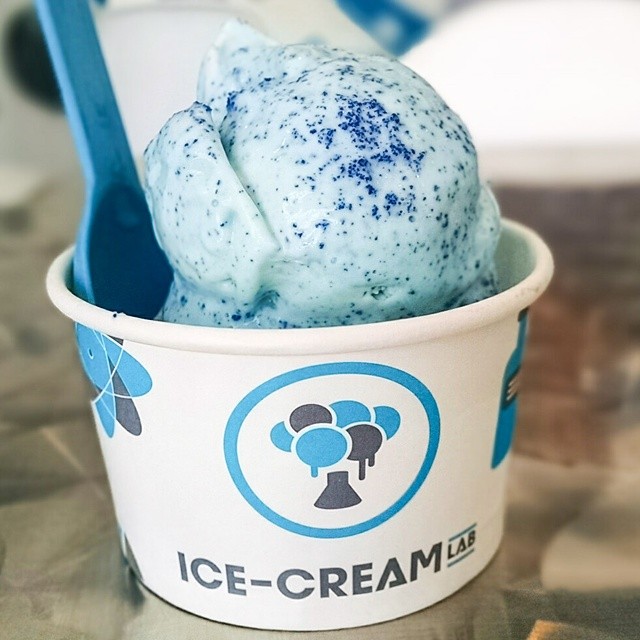 ice cream in small plastic cup with spoon