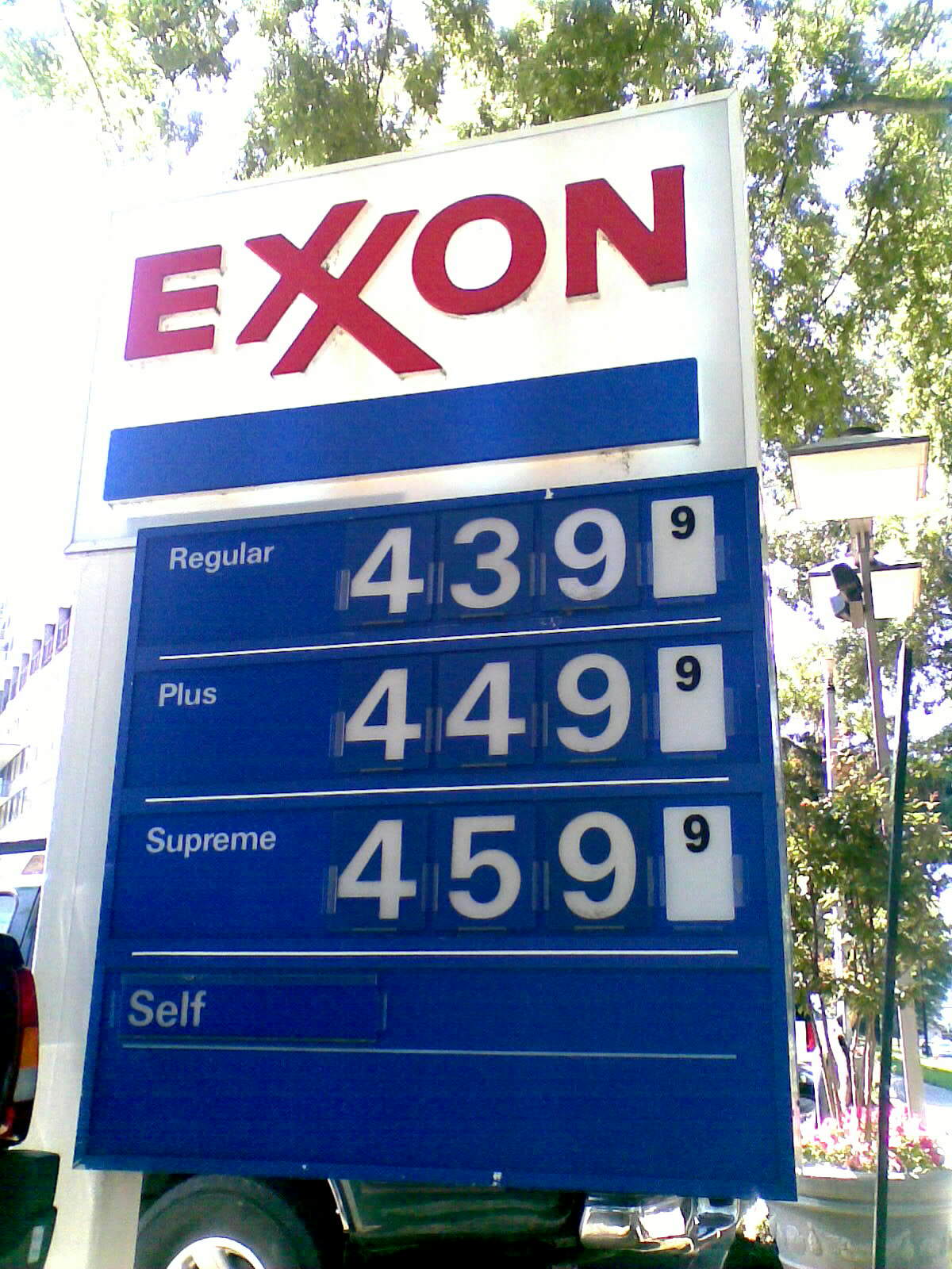 a gas station sign sits along the side of a building