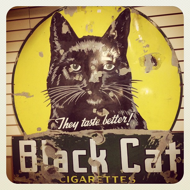 a sign for back cat cigarettes with a black cat on it