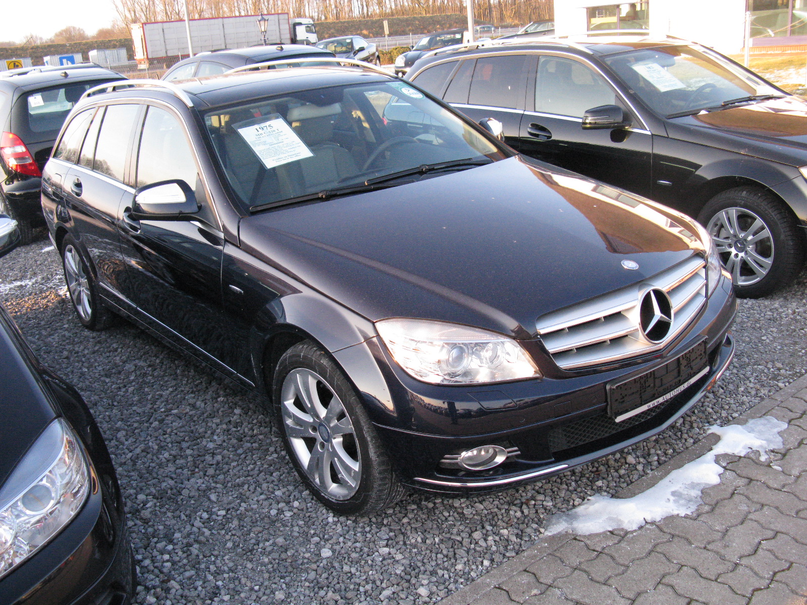 a car in the parking lot and two cars sitting next to each other