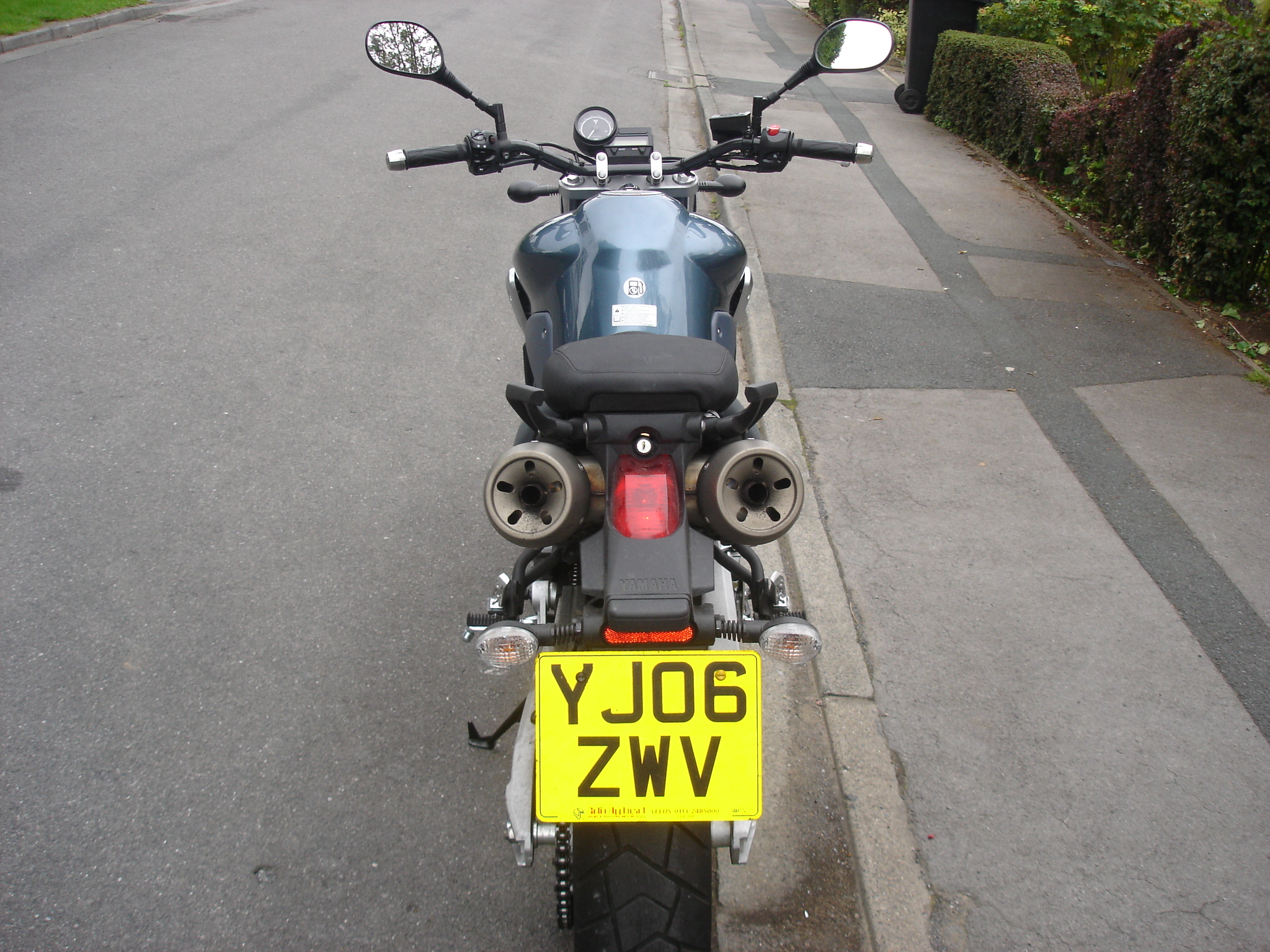 a motorcycle is shown parked on the side of a road