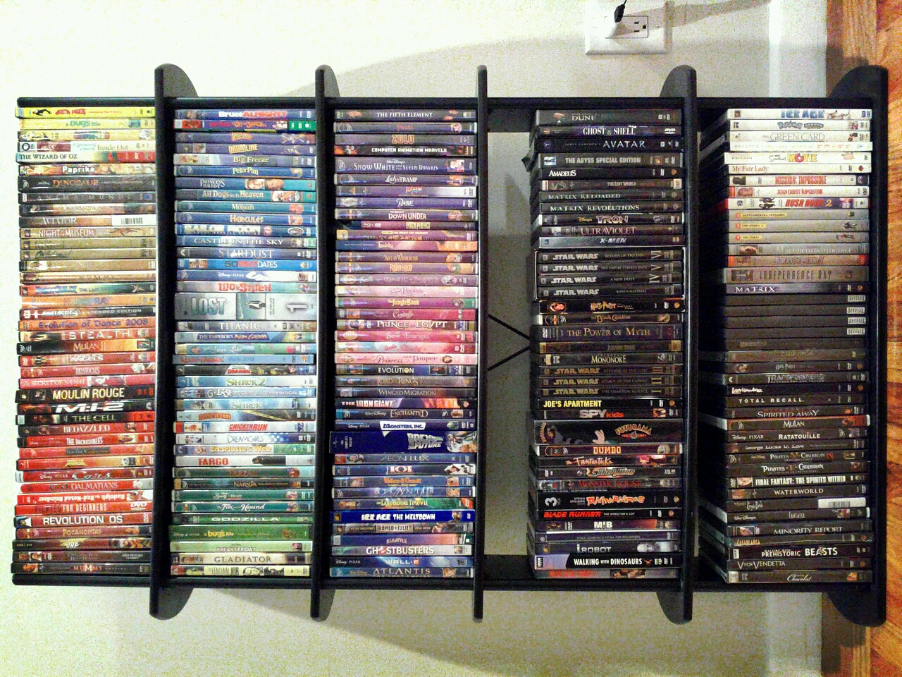 there is a book shelf with some movies