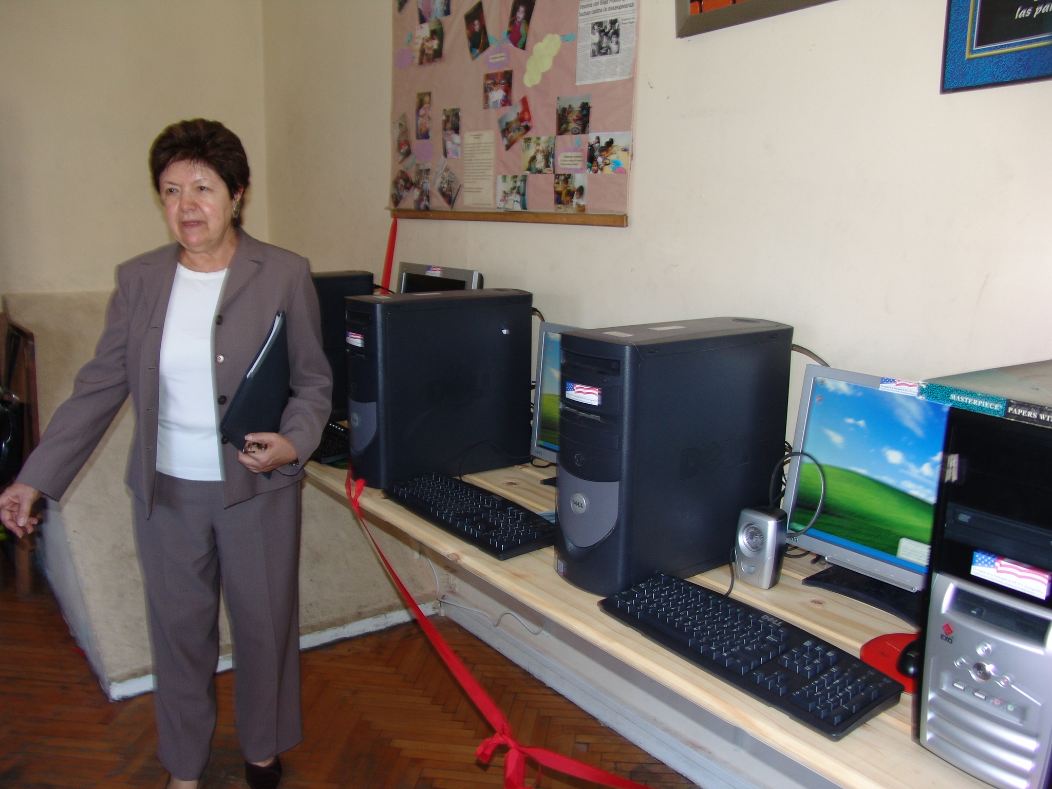 a woman is standing next to computer equipment