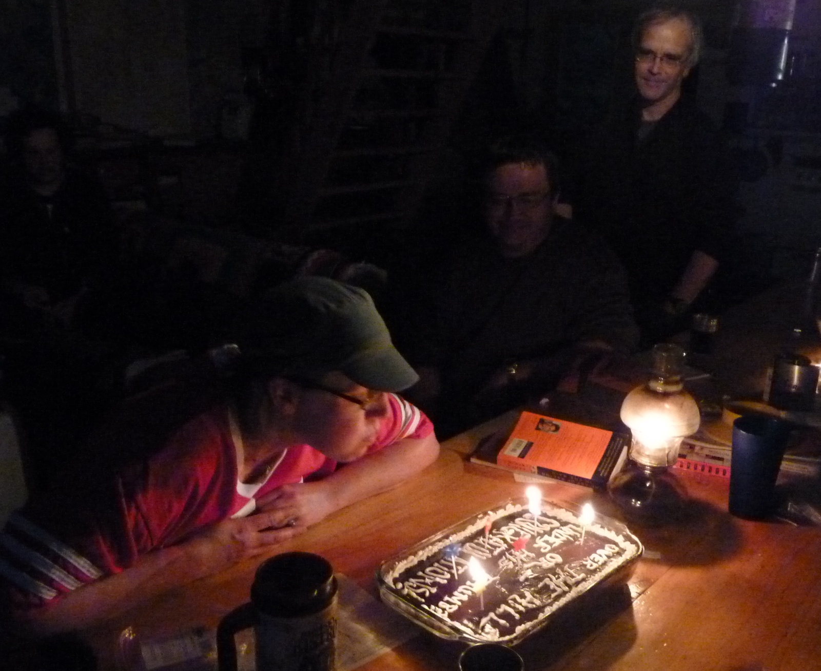 a person sitting at a table with a cake