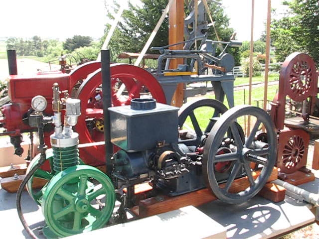the old steam engine is displayed on a wooden stand