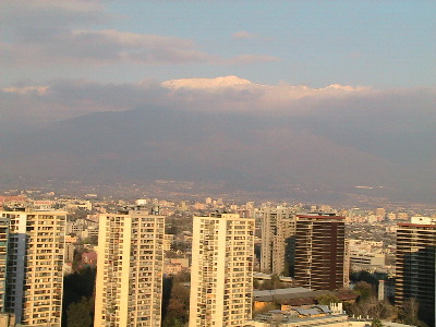 a large city with buildings and hills in the distance