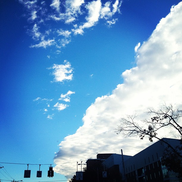 a cloud in the sky above an intersection