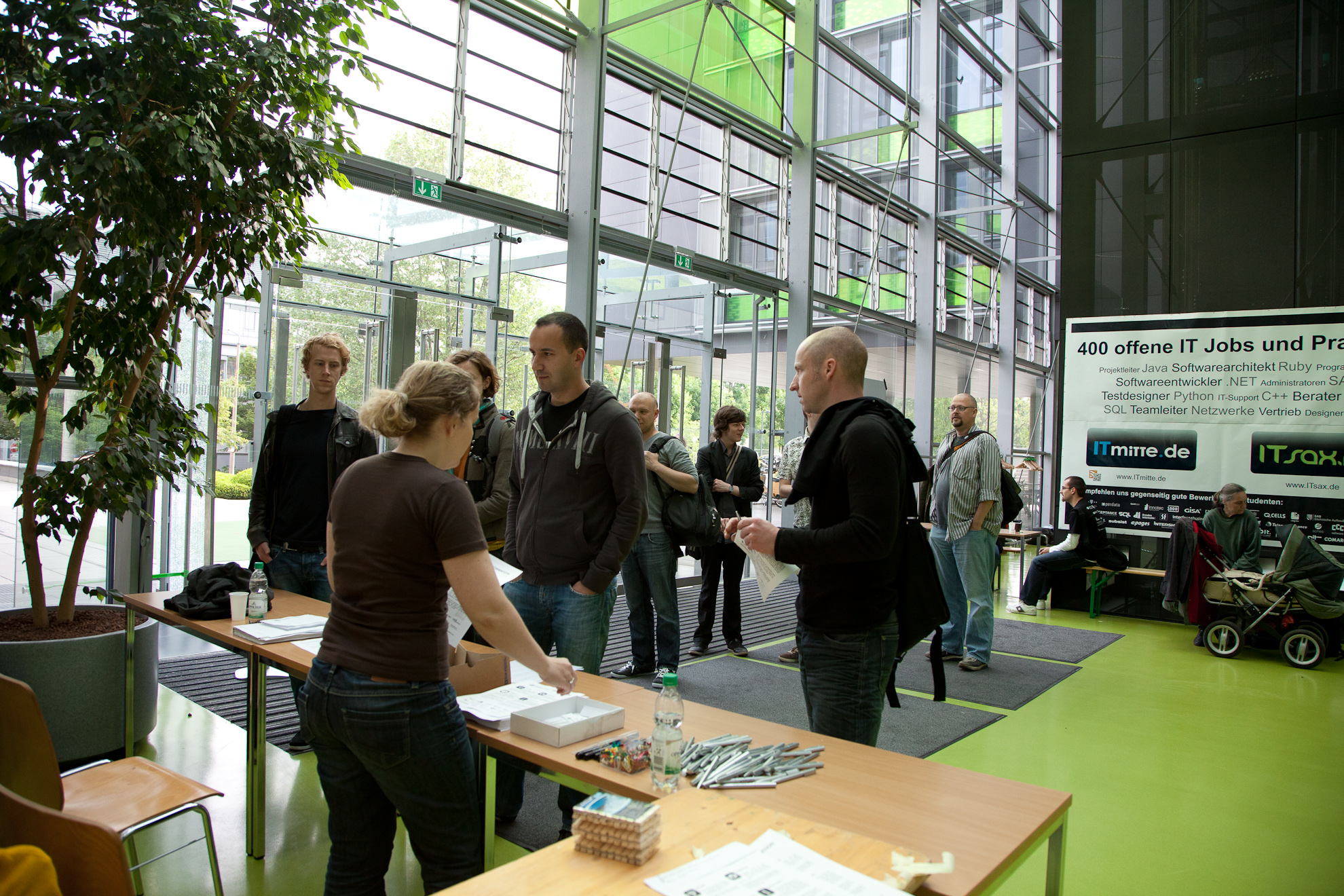 a bunch of people that are standing in front of a table