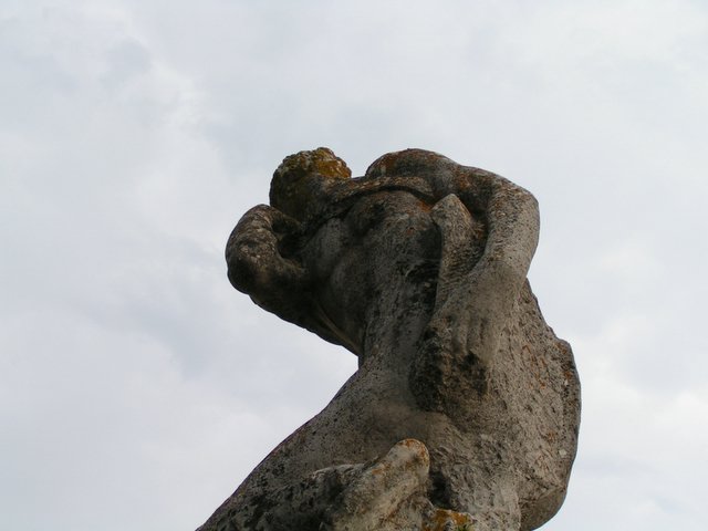 there is a stone statue on top of the hill