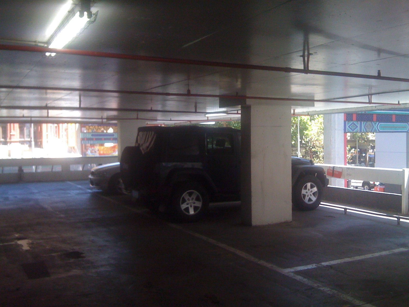 a black jeep parked in an empty garage