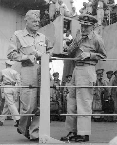 two men in military uniforms standing near one another