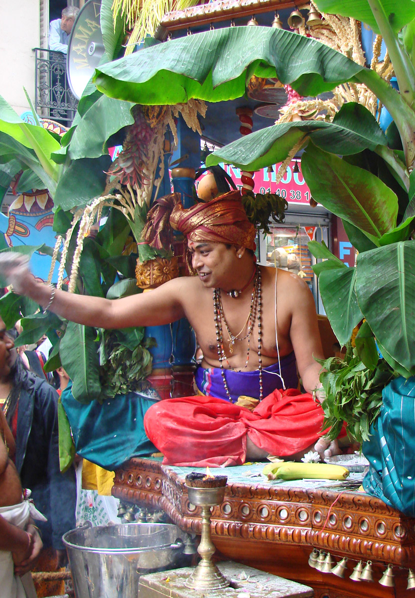 a man in a colorful outfit next to some plant life