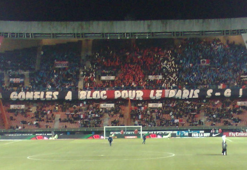 a group of men standing on top of a soccer field