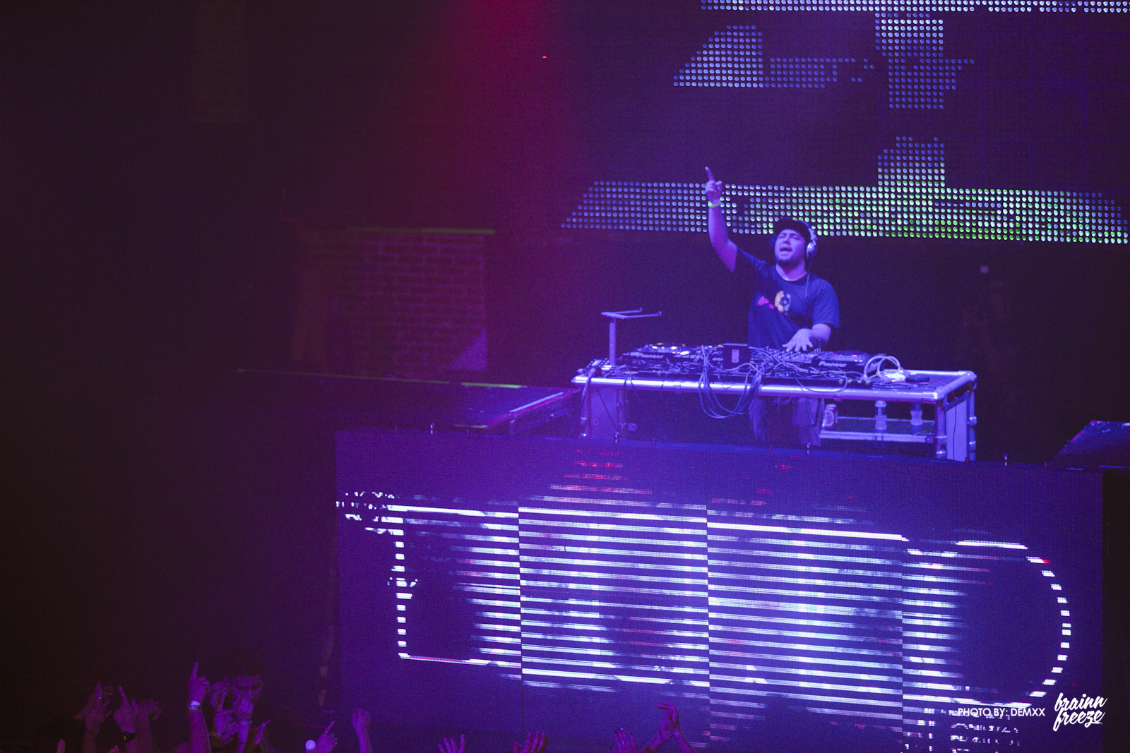 dj playing on a dj equipment during a concert